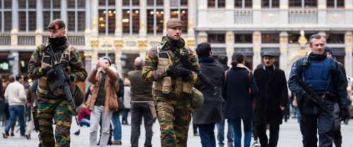 Belgian Army soldiers and police officers patrol in the picturesque Grand Place in the center of Brussels on Friday, Nov. 20, 2015. Salah Abdeslam, a French national who lived in Molenbeek, Belgium, is currently the subject of an international manhunt after the Paris attacks. Security has been stepped up in parts of Belgium as a precaution. (AP Photo/Geert Vanden Wijngaert)