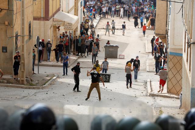Protesters throw stones towards riot police during a demonstration against alleged corruption in the provincial town of Imzouren, Morocco, June 2, 2017. While some anger in the Al Hoceima protests has been directed at "Makhzen" - the royal governing establishment, the demonstrations in northern Morocco, as in 2011, have not been directed at the king. Morocco has a deeply rooted monarchy, the Muslim world's longest-serving dynasty. REUTERS/Youssef Boudlal