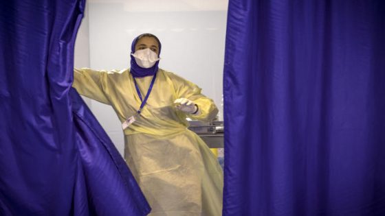 A Moroccan health worker is pictured at a Covid-19 vaccination centre, part of the local "smart vaccinodrome" campaign, in the Errahma district near the city of Casablanca, on August 9, 2021. - The digitalised centre aims to vaccinate 3,000 to 4,000 people per day and has its entire vaccination process through a QR code system that allows citizens to be traced throughout the vaccination circuit. (Photo by FADEL SENNA / AFP)